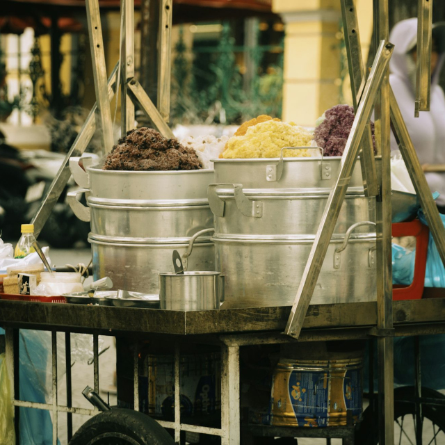 A person pushing a cart with food on it