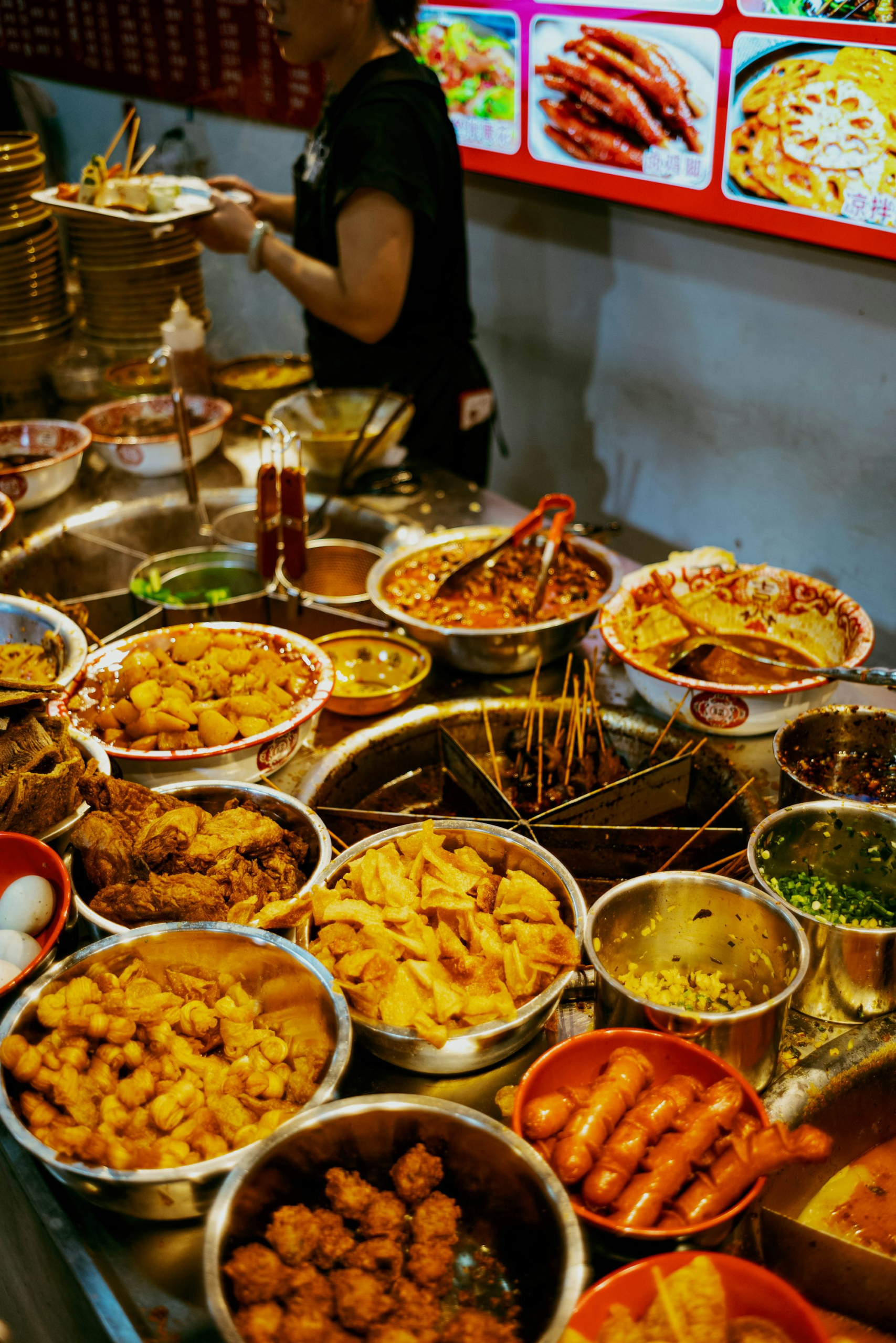 A woman standing in front of a table full of food