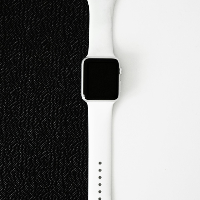 An apple watch sitting on top of a black cloth